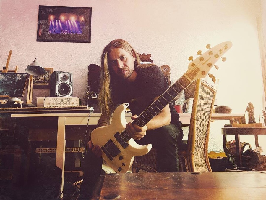 Kevin Storm in his studio with a white ESP guitar